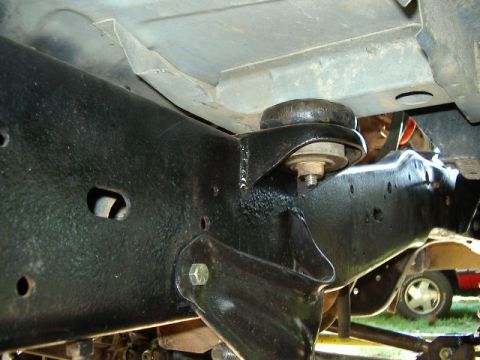 1985 Ford Bronco - Close-up view of vehicle frame and suspension components, with another vehicle partially visible in the background.