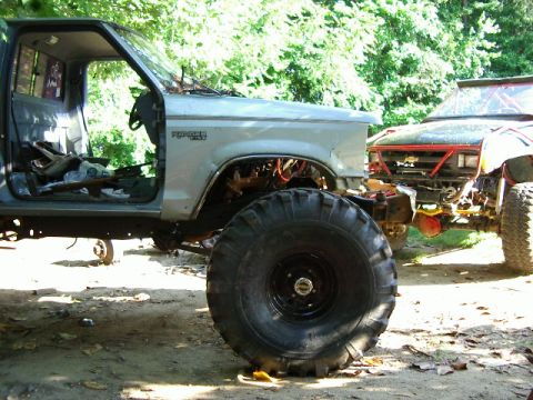 1985 Ford Bronco - This Ford Ranger pickup truck is heavily modified with large off-road tires and appears to be undergoing restoration or customization.