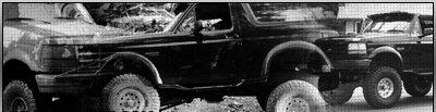 1995 Ford Bronco - Two Ford Bronco SUVs are visible in this image, with the one in the foreground clearly identifiable.