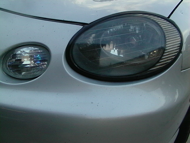 1999 Ford Taurus front headlight assembly with dark tint