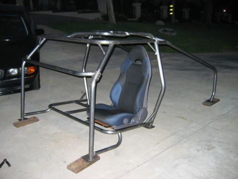 1985 Ford Bronco - A custom-built roll cage with a racing seat is shown, not a 1985 Ford Bronco.