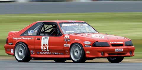 1993 Ford Mustang - 1993 Ford Mustang Cobra R race car on track, displaying sponsor decals and racing numbers.