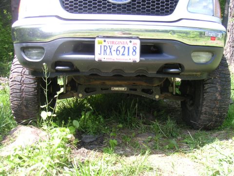 1994 Ford Bronco - This lifted truck features large off-road tires and a custom suspension system, as seen from the front.