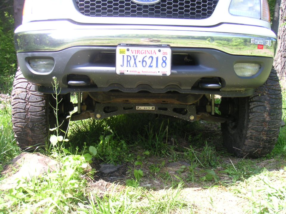 Front view of lifted truck with large tires and Virginia license plate JRX-6218