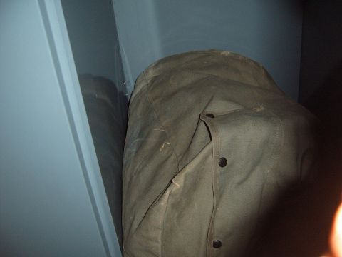 1988 Ford Bronco - A car cover hides the vehicle, making identification impossible.