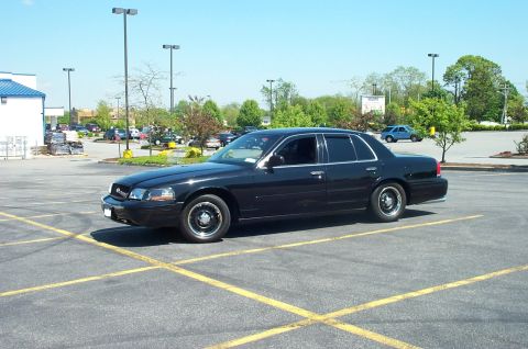 1999 Ford Crown Victoria - This black 1999 Ford Crown Victoria is seen from a three-quarter front angle in a parking lot.