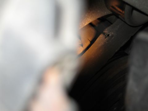 1992 Ford Crown Victoria - Damaged engine hose showing a hole and wear.