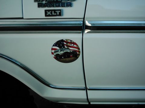 1978 Ford Bronco - A white 1978 Ford Bronco XLT is shown from the side, a decorative sticker.