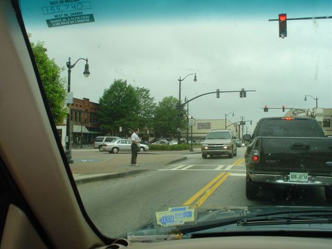 1981 Ford Bronco - A silver SUV is seen at a street intersection on an overcast day.