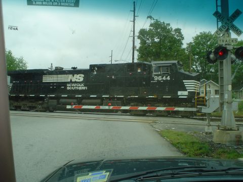 1981 Ford Bronco - A Norfolk Southern train engine passes through a railroad crossing.