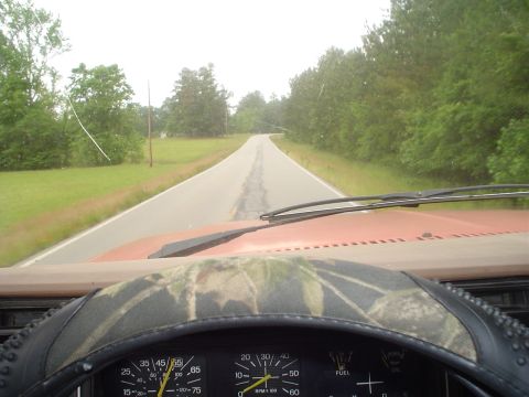 1981 Ford Bronco - Driving down a two-lane road surrounded by trees, with the vehicle's dashboard in the foreground.