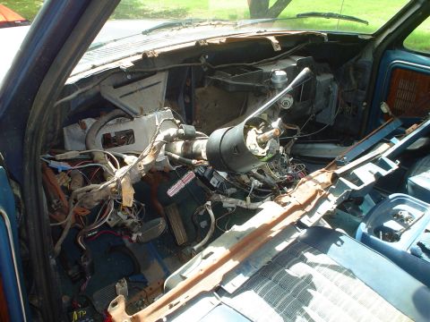 1981 Ford Bronco - The interior of this truck is in disarray, with wires exposed and the dashboard severely damaged.