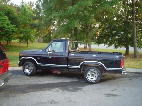 1981 Ford Bronco - Side view of a black 1980 Ford F-150 pickup truck with chrome trim and wheels.