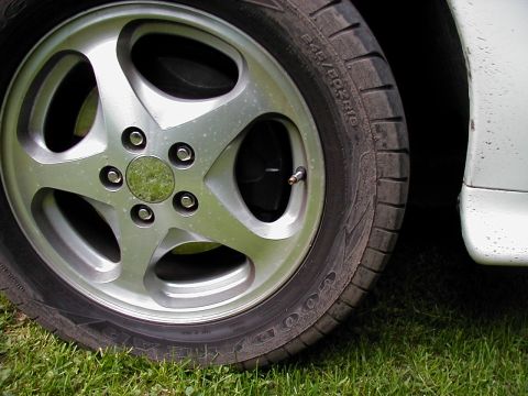 1997 Ford Taurus - A close-up view of a car's wheel and tire, showing the tread pattern and alloy rim details.