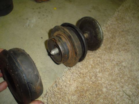 1993 Ford Taurus - This photo shows a damaged rubber bushing and a metal suspension component, likely from a car's subframe.