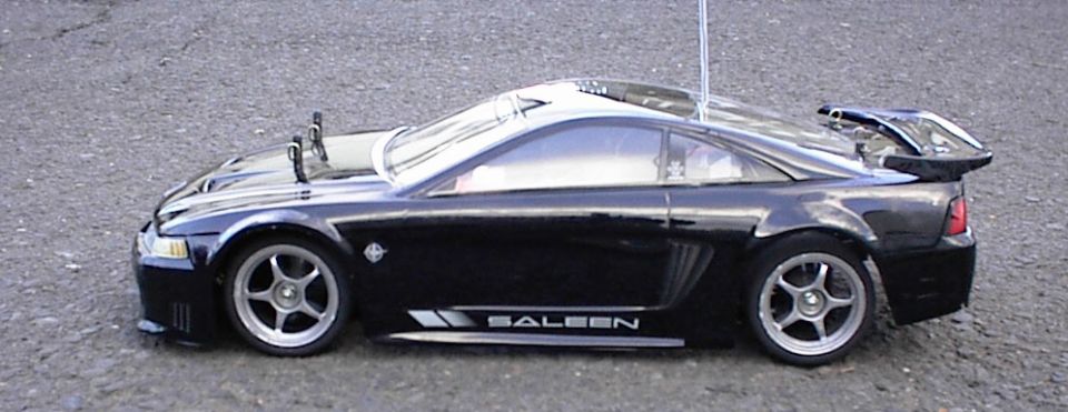 Black RC Mustang-style model car with SALEEN decal, side view on pavement