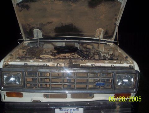 1984 Ford Bronco II - Engine bay of a 1984 Ford Bronco II, showing the engine and surrounding components under the open hood.