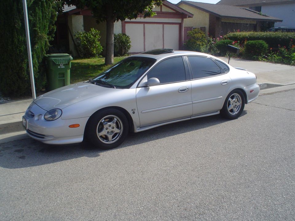 Silver sedan parked on a residential street, viewed from the front quarter