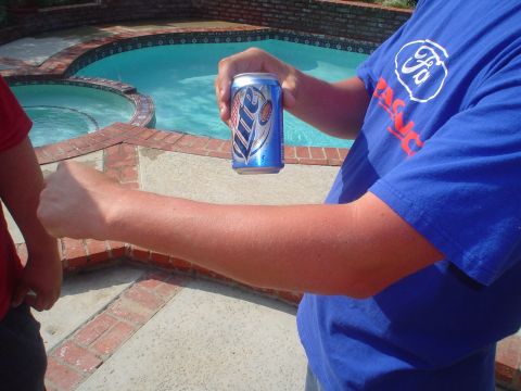1993 Ford Taurus - Person holding a can of Miller Lite next to a pool.