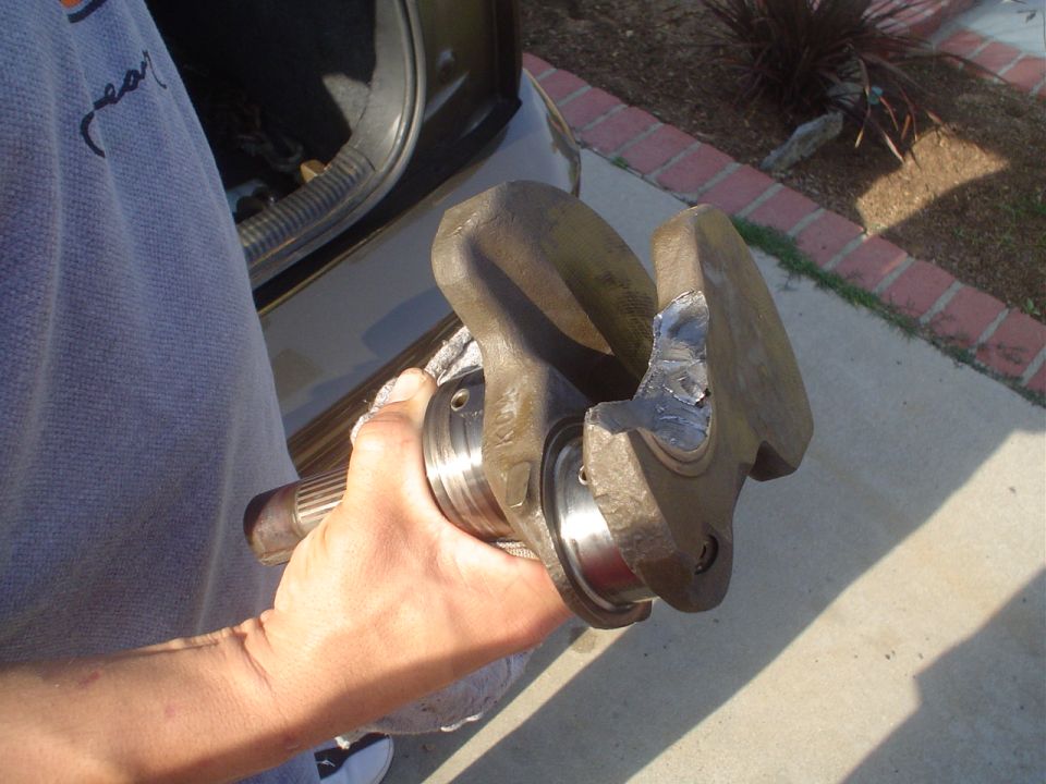 Damaged crankshaft held by a person