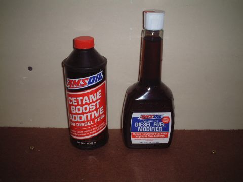 2000 Ford Excursion - Two bottles of AMSOIL fuel additives, one for cetane boost and one for diesel fuel modification, are displayed.