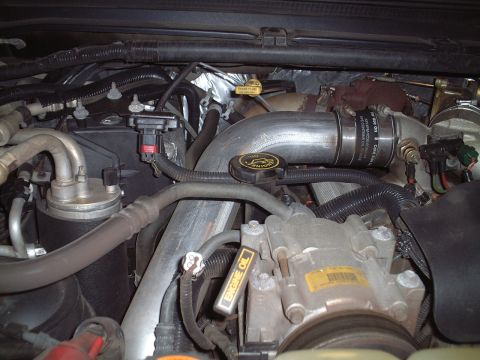2000 Ford Excursion - Close-up view of a vehicle's engine bay, showing various components and fluid lines.