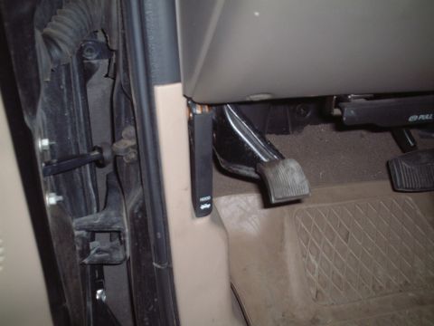 2000 Ford Excursion - Interior view of the driver's side footwell, including pedals and door hardware.