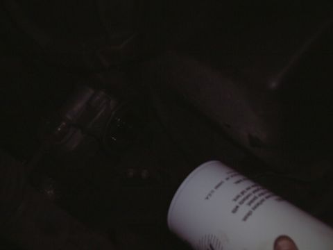 2000 Ford Excursion - Close-up of an oil filter and some engine parts, with legible text on the filter.