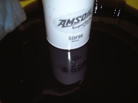 2000 Ford Excursion - An AMSOIL SDF99 oil filter is shown partially submerged in dark fluid.