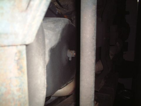 2000 Ford Excursion - Close-up view of a vehicle's oil pan and drain plug, suggesting an oil change service.