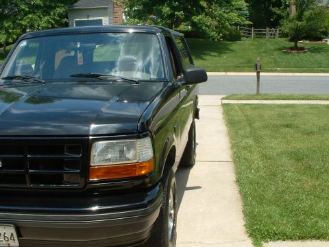 1994 Ford Bronco - This black 1994 Ford Bronco is parked on a residential driveway.