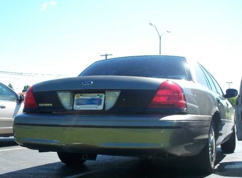 1998 Ford Crown Victoria - The rear of a Ford Crown Victoria is shown, parked in a lot on a sunny day.