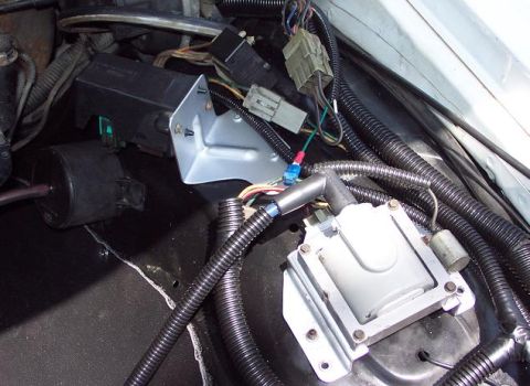 1985 Ford Crown Victoria LTD - Close-up view of the engine compartment, showing the ignition coil and various electrical components and wiring.