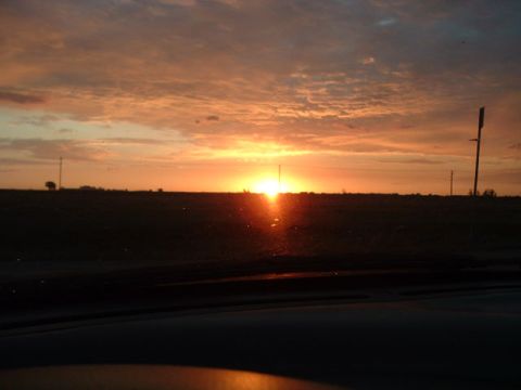 1994 Ford Probe - The sun sets over a dark field, casting an orange glow across the sky.