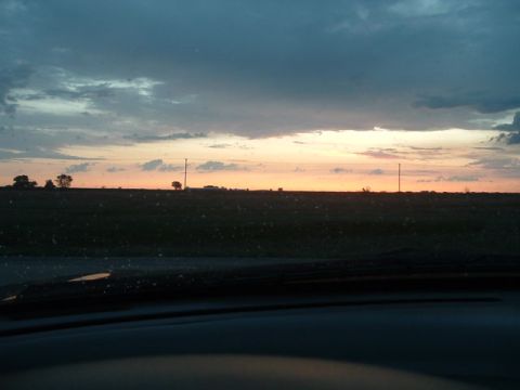 1994 Ford Probe - The sky displays a gradient of colors during sunset over a rural landscape with a few trees and utility poles visible.