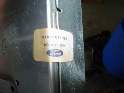 1981 Ford Bronco - A Ford warranty sticker is affixed to a metal panel, advising "WARRANTY ITEM DO NOT OPEN".
