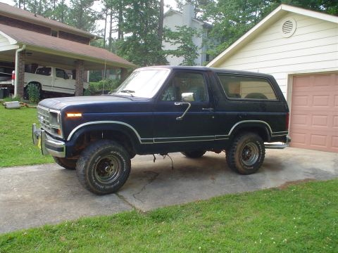 1981 Ford Bronco - 1981 Ford Bronco parked in driveway with a white pickup truck in the background.