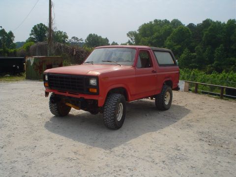 1981 Ford Bronco - This red Ford Bronco is equipped with off-road tires and aftermarket wheels.