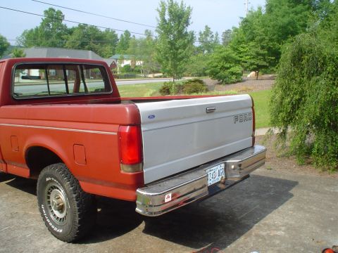 1981 Ford Bronco - This Ford pickup truck has a two-tone paint scheme with a silver tailgate and red body.