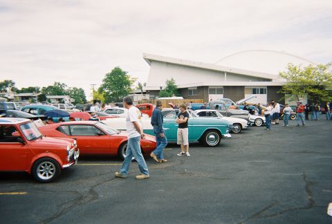 1972 Ford Ranchero - A teal 1955 Chevrolet Bel Air is parked at a car show alongside other classic automobiles.