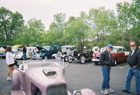 1972 Ford Ranchero - Attendees gather around various vintage automobiles displayed at an outdoor car show event.