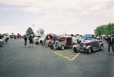 1972 Ford Ranchero - A variety of custom cars are on display at an outdoor event.