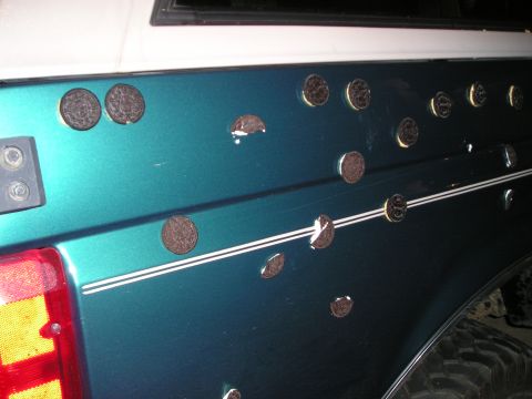1996 Ford Bronco - Teal and white Ford Bronco with Oreos stuck to the side panel.