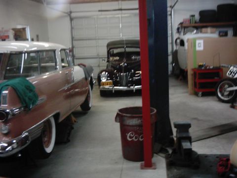 1978 Ford Bronco - A garage scene shows two vintage automobiles and various workshop equipment.