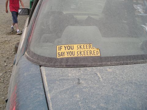 1996 Ford Bronco - A sticker on the rear window of a dusty car reads "IF YOU SKEER SAY YOU SKEERED".