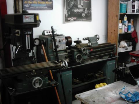 1978 Ford Bronco - Workshop scene a milling machine and a metal lathe, with posters and supplies visible.