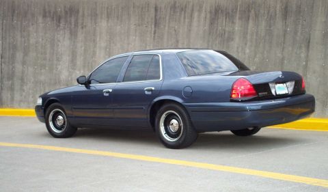 1998 Ford Crown Victoria - This 1998 Ford Crown Victoria is shown from the rear 3/4 angle, a dark blue exterior.