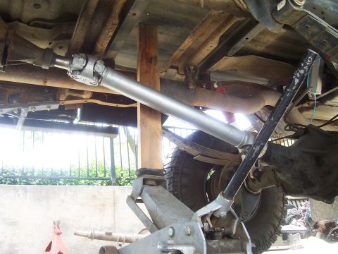 1994 Ford F-150 - Vehicle's driveshaft and suspension components are visible while being worked on, supported by jacks.
