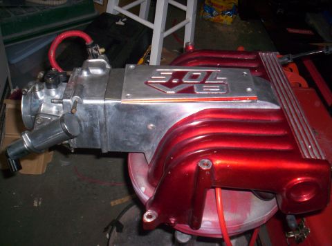 1989 Ford Bronco II - Customized 3.0L V6 intake manifold, likely for a Ford vehicle, with a metallic red finish and silver lettering.