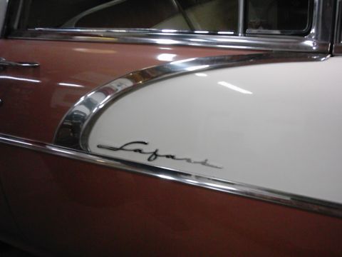 1978 Ford Bronco - Detail of a car door showing the 'Safari' script emblem and two-tone paint scheme.